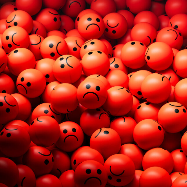 Illustration of a pile of red balls with sad faces. -- health coverage from STAT