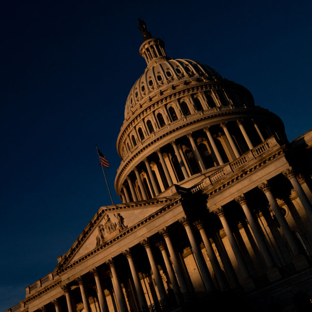 The US Capitol building shot through a tilted angle under dark blue sky — health policy coverage from STAT