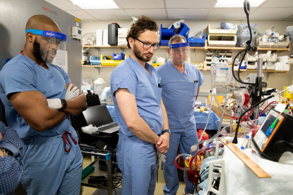 Research technician Chijoke Chukwudi, MD, principal investigator Seyed Alireza Rabi, MD, and engineer and president of VentriFlo Doug Vincent, oversee a pig heart that is going through perfusion in the "heart in a box" system, at Massachusetts General Hospital, on June 27, 2024, in Boston, Massachusetts. The "heart in a box" system, provides organ perfusion by oxygenating, warming, and pumping the blood through the heart to re-animate and keep it alive and viable for transplant.